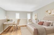 Thumbnail 3 of 16 - Affinitee at Stone Mountain Apartments photo of a bedroom with a bed and a desk with a chair