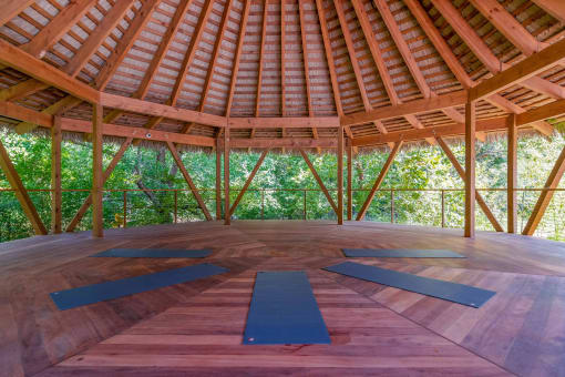 Affinitee at Stone Mountain Apartments photo of a yoga shala with yoga mats on the floor and trees in the background