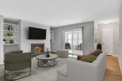 Thumbnail 11 of 16 - Affinitee at Stone Mountain Apartments photo of a living room with a couch and a chair and a fireplace